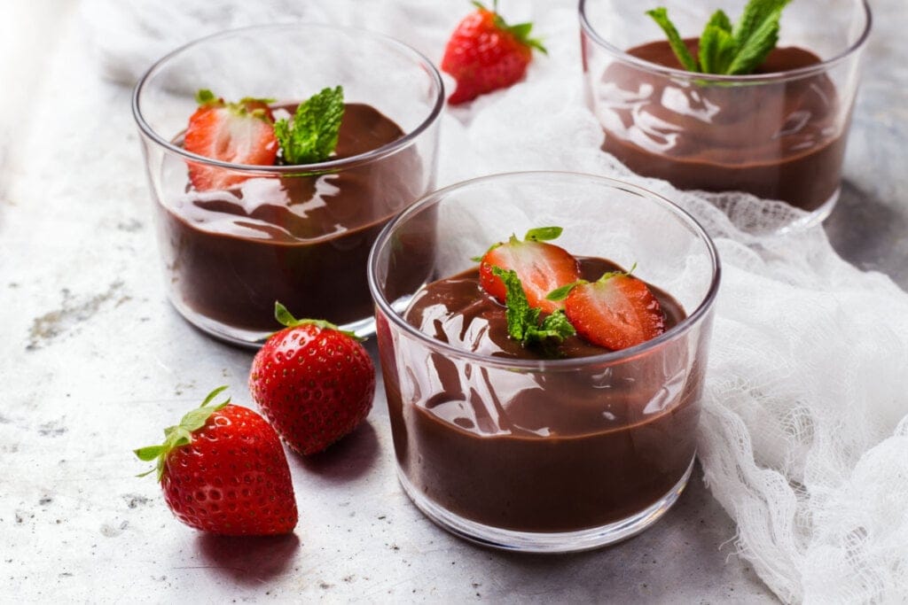 Mousse de chocolate com morango em travessas de vidro. 