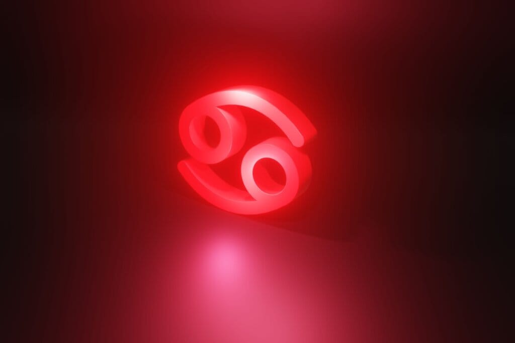 Ilustração em vermelho do símbolo do signo de Câncer em fundo vermelho escuro