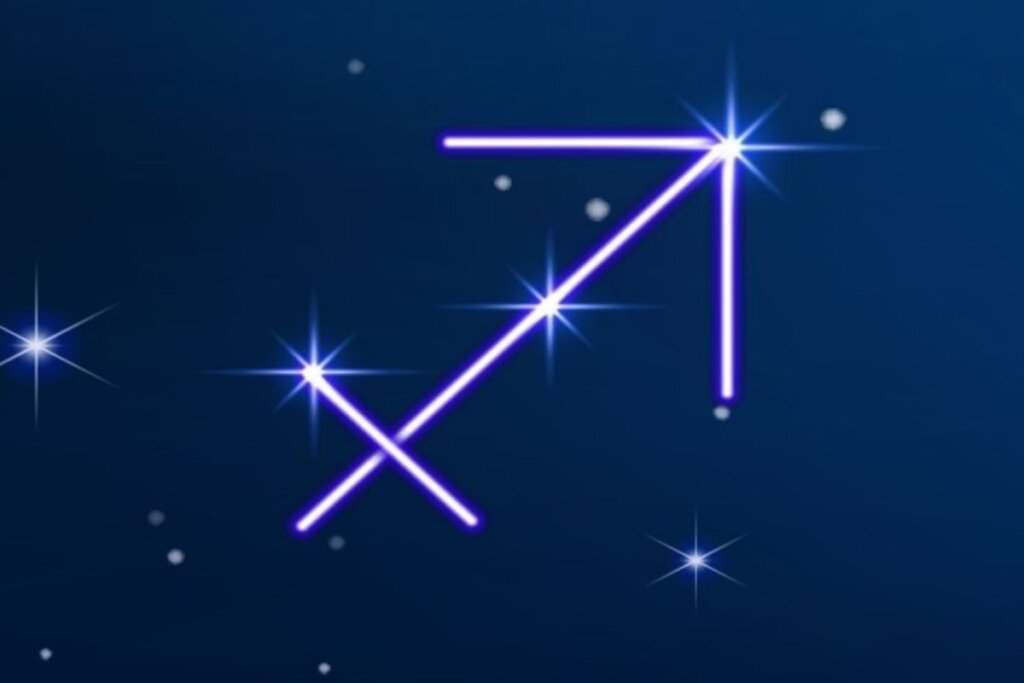 Símbolo do signo de Sagitário em roxo em fundo azul-escuro com pontos de luz simbolizando as estrelas