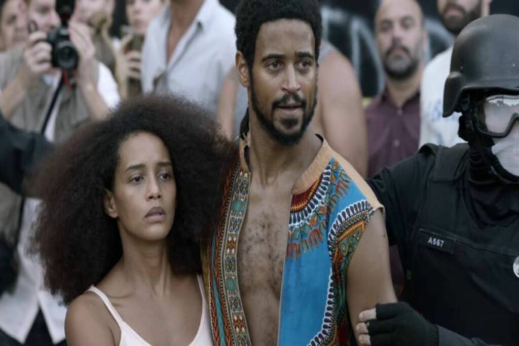 Taís Araújo e Alfred Enoch no filme Medida Provisória