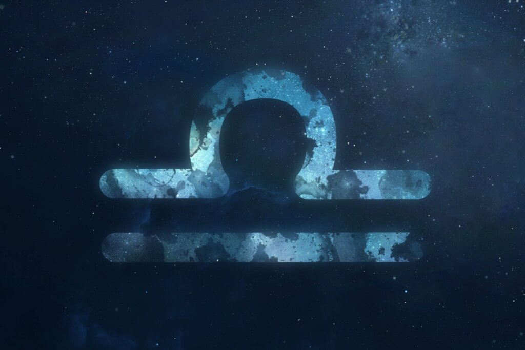 simbolo do signo de libra em fundo azul escuro sobre fundo azul-escuro estrelado