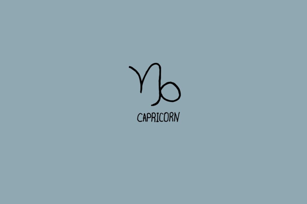Ilustração do signo de capricórnio em um fundo cinza com o nome do signo embaixo