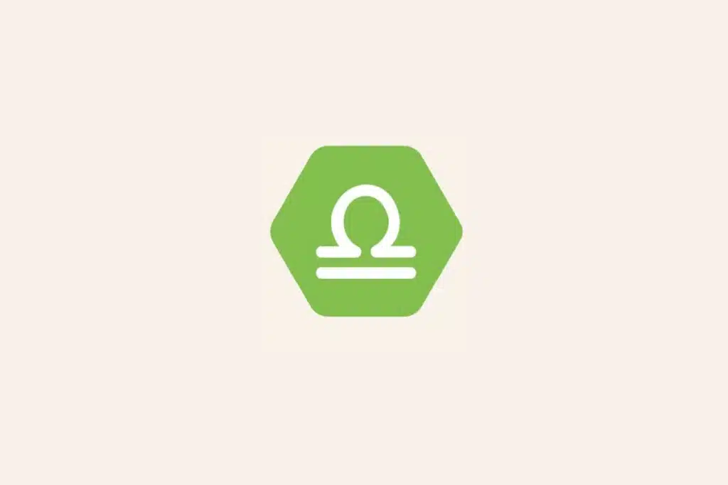 Ilustração do signo Libra, com símbolo branco representando uma balança sobre hexágono verde-claro em fundo bege