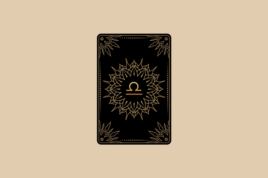 Ilustração de uma carta de tarô preta em fundo bege, com detalhes dourados em mandala e o símbolo do signo de Libra no centro.