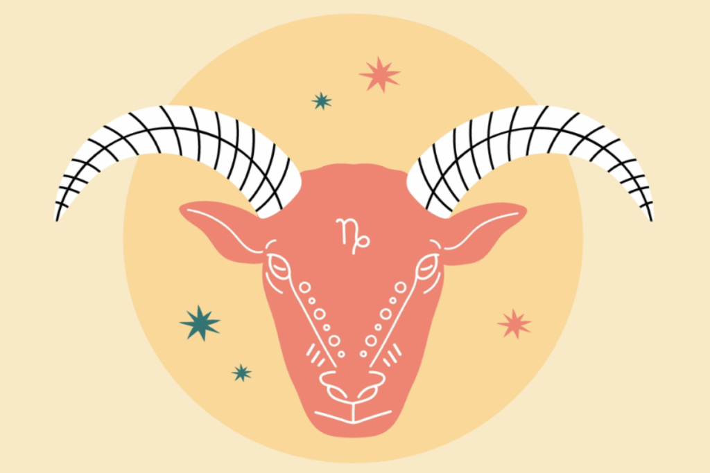A imagem apresenta a cabeça de uma cabra estilizada, utilizada para representar o signo de Capricórnio. O rosto do animal aparece de frente, em tom coral, com formato alongado e diversos detalhes decorativos desenhados em branco ao redor dos olhos, do focinho e das laterais da face.