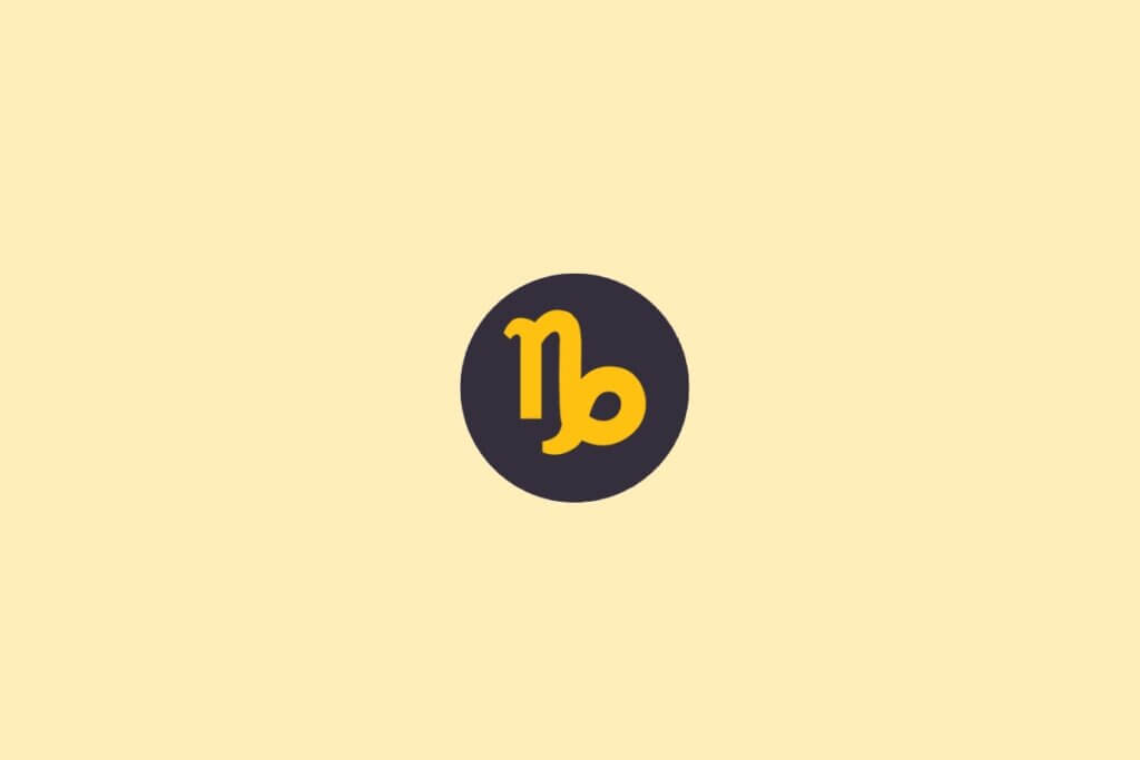 Um símbolo do signo de Capricórnio em amarelo, dentro de um círculo escuro, sobre um fundo claro bege