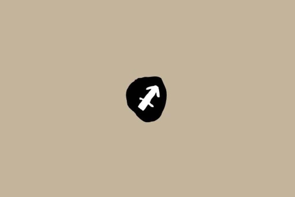 Símbolo do signo de Sagitário em branco dentro de um círculo preto sobre um fundo bege