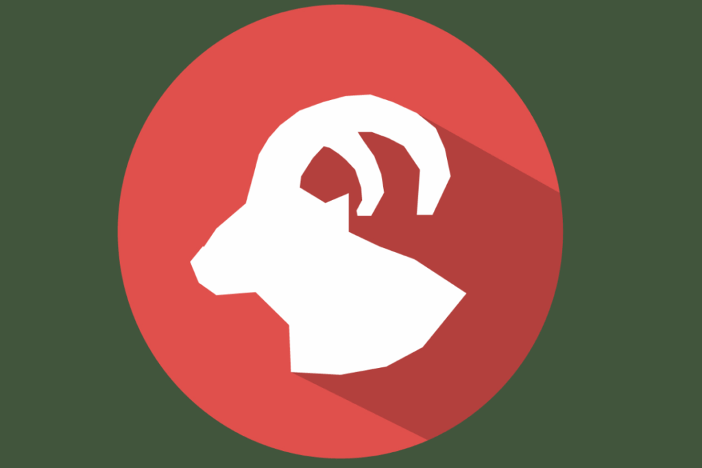 a imagem representa o signo de Capricórnio com a silhueta branca da cabeça de uma cabra, vista de perfil, com um grande chifre curvado. O símbolo aparece sobre um círculo vermelho.